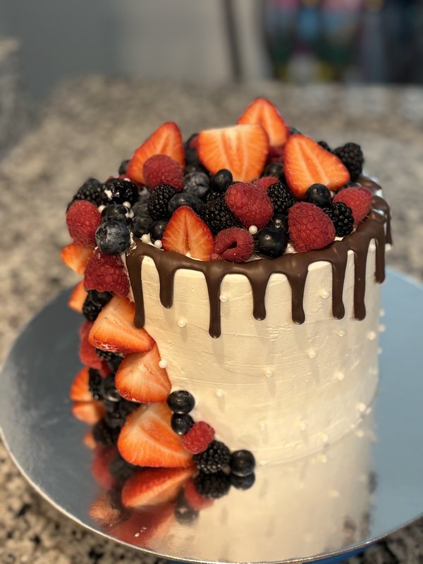 Chocolate ganache cake with cascading fresh berries