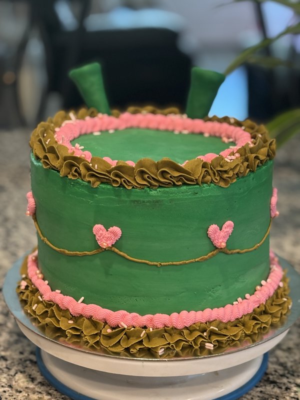 Vintage pink and green buttercream cake with bow topper