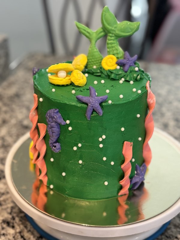 Under-the-sea cake with mermaid tail, starfish, seahorse, and coral details